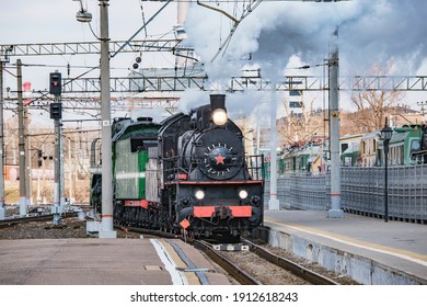 Retro Train Arrives To The Railway Station Building. Moscow.