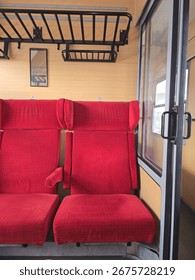 Retro train cabin with empty red seats