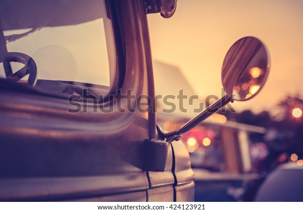 Retro truck under sunset with\
booked light of shop and reflect in truck side mirror, vintage\
style