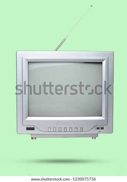 Retro tube TV and remote control on a\
brown background. Top view, vintage video\
technology\
