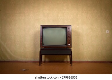 Retro TV on a background of vintage wallpaper in old room with vignetting - Shutterstock ID 179916533
