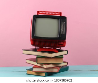 Retro Tv And Stack Of Books On Pink Background. TV Distance Learning.