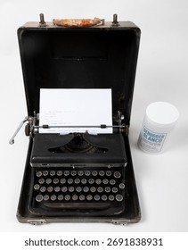 Retro typewriter holding C++ code beside Debugger Blanco bottle. Humor concept blending old writing tools and software debugging.