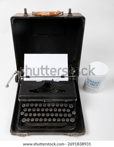 Retro typewriter holding C++ code beside Debugger Blanco bottle. Humor concept blending old writing tools and software debugging.