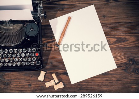 Retro typewriter placed on wooden planks. Aerial angle of view