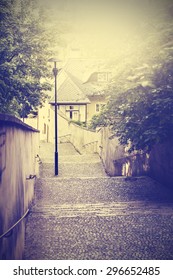 Retro Vintage Filtered Nostalgic Photo Of Old Narrow Street In Prague, Czech Republic.