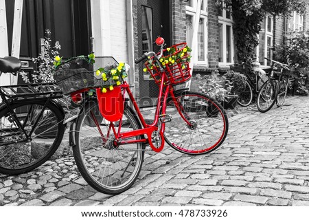 Retro vintage red bicycle on cobblestone street in the old town. Black And White Toned. Ribbe, Denmark