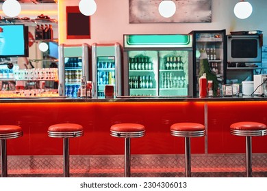 Retro, vintage and stools with interior in a diner, restaurant or cafeteria with funky decor. Trendy, old school and chairs by a counter or bar in groovy, vibrant and stylish old fashioned empty cafe - Shutterstock ID 2304306013