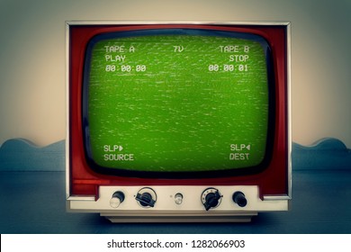 A Retro Vintage TV Showing A Green VHS Tape Screen Tracking A Noisy Signal Coming From A Double Deck. Cool Retro Vintage Backdrop.
