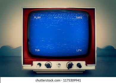 A Retro Vintage TV Showing An Old Bad Broken VHS Tape Playing. Blue Screen With PLAY And TAPE Text.
