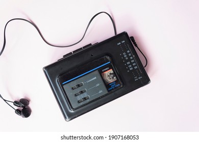 Retro Walkman And Headphones On Pink Background