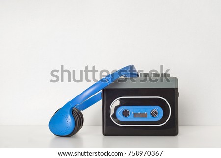 Retro walkman and headphones on the white shelf