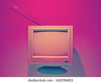 Retro Wave, 80s Concept. Old Tv With Antenna, Neon Light. Night Television. Top View, Flat Lay