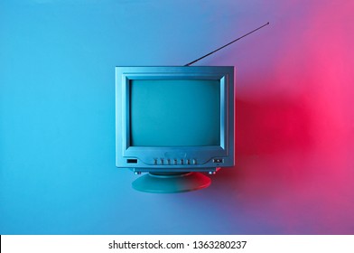 Retro wave, 80s. Old tv with antenna with neon light. Top view, minimalism