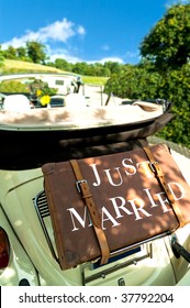 A retro wedding car with luggage marked 'just married'
