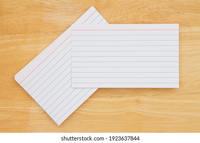 Retro white paper index cards on wood desk with copy space for your message