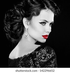 Retro woman. Fashion model girl portrait. Black and white photo. Isolated on black background.