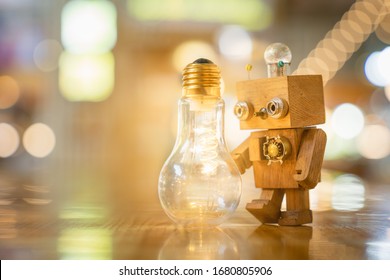 Retro wood robot hold light bulb with two hand with bokeh light background,, nature power energy concept. - Powered by Shutterstock - Get 15% off with code: PIKWIZARD15