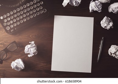 Retro writer, journalist desk. High angle view of blank paper sheet on a wooden desk with copy space