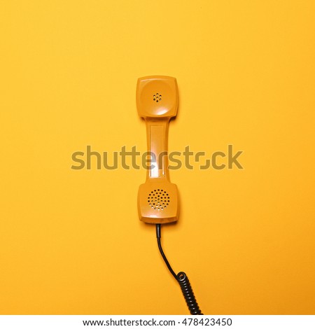 Retro yellow telephone tube on yellow background - Flat lay