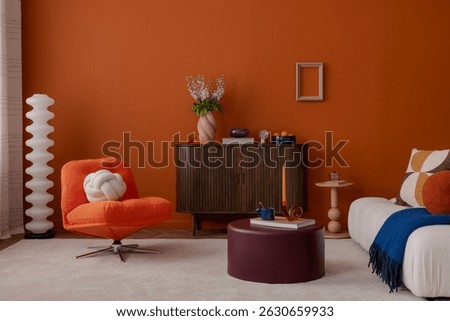 Retro-inspired living room with orange accent wall, soft white seating, sculptural decor, and pastel accessories. A playful and sophisticated interior setup.