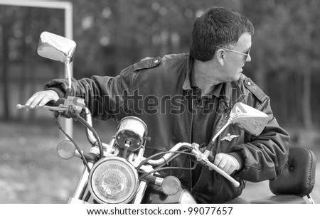 Similar – Senior man repairing damaged motorcycle engine