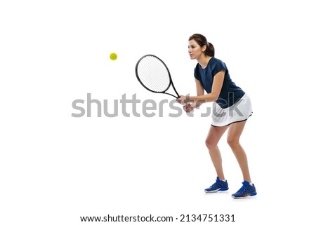 Return. Dynamic portrait of young sportive woman, tennis player practicing isolated on white background. Healthy lifestyle, fitness, sport, competition concept. Female athlete in motion, action