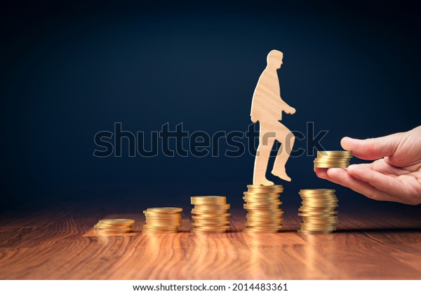 Return on\
investment, growing savings or wage income concept. Coins and\
wooden person going on increasing columns of coins. Helping hand\
adds more money. Successful investment\
concept.
