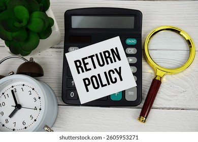 Return Policy text message with calculate, alarm clock and magnifying glass on wooden background