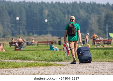 Return from vacation, end of vacation, a man with a suitcase
