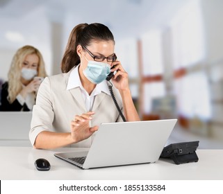 Return To Work After Covid-19 Quarantine. Busy Millennial Woman In Protective Mask Talking On Phone