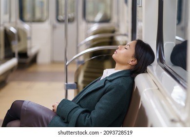 Returning home late. Empty subway wagon with sleeping african american businesswoman working in office overtime till night. Young black female tired and depressed riding in public transport asleep - Powered by Shutterstock