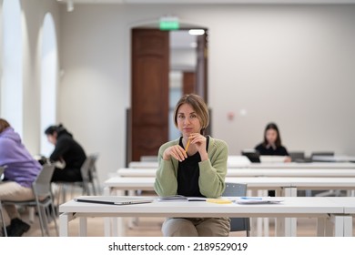 Returning To University As Mature Student. Happy Female Adult Learner Smiling At Camera While Studying In Classroom, Middle-aged Woman Getting Second Higher Education, Attending Educational Courses