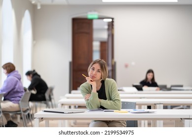 Returning To University As Mature Student. Happy Female Adult Learner Smiling At Camera While Studying In Classroom, Middle-aged Woman Getting Second Higher Education, Attending Educational Courses