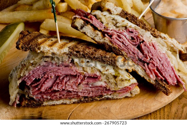 Reuben Sandwich. Classic traditional American\
sandwich. Pastrami and corned beef on grilled rye bread, melted\
Swiss cheese, sauerkraut, topped with thousand island dressing\
served french fries.