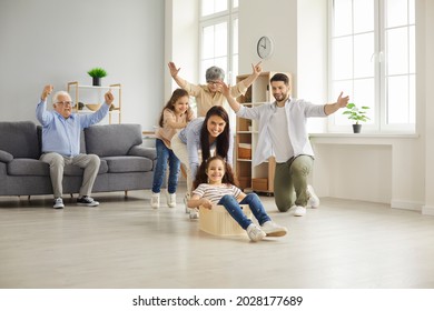 Reunion of generations. Happy big family with children have fun together at home playing. Mom, dad, little daughters and grandparents play with a plastic container in the living room