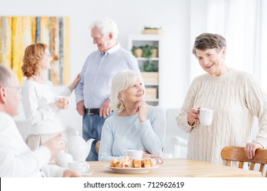 Reunion Of Happy Senior People Enjoying Their Meeting, Talking And Sharing Memories While Drinking Tea At Home