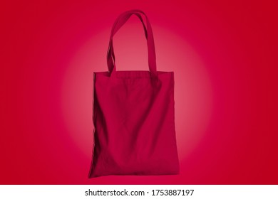 Reusable Bag For Groceries And Shopping, Red Fabric Tote Bag On Red Background.