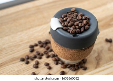 Reusable Coffee Eco Cup. Toughened Glass Cup & Natural Cork Band. Secure Silicon Lid. Reusable Eco Cup On A Wooden Background.Eco-Friendly, Spill Proof Travel Mug With Lid | Black. Keep Cup