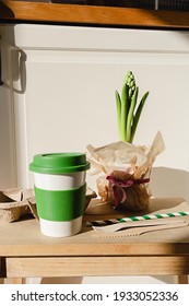 Reusable eco friendly bamboo cup for take away coffee and wooden cutlery set in the modern kitchen. Bring your own cup concept. Zero waste, sustainable lifestyle. Plastic free concept.