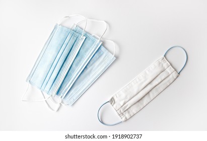 Reusable Face Mask And Medical Single Use Mask On On White Background. Flat Lay. Zero Waste Concept.