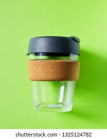 Reusable Glass Takeaway Coffe Cup With Plastic Lid On Green Background, Flat Lay