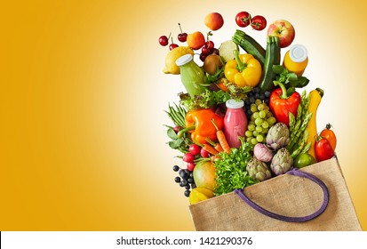 Reusable grocery bag filled with healthy food and smoothie including assorted different colored fruits and vegetables - Powered by Shutterstock