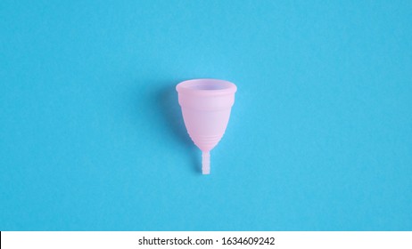 Reusable Menstrual Cup Isolated On Blue Background. Alternative Menstrual Hygiene Product. Critical Days, Menstruation Cycle, Female Healthcare Concept