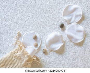 Reusable Organic cotton pads with Zero waste for removing makeup on a terry towel, sea round stones, a place for text. - Shutterstock ID 2214260975