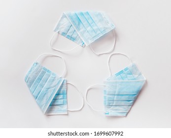 Reuse - Reusable Surgical Mask Folded In The Form Of A Sign And A Recycling Symbol - Material Recycling