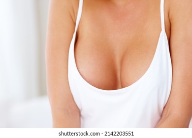 Revealing her ample assets. Cropped shot of a young womans cleavage.