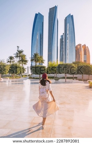 Revel in the beauty of Abu Dhabi's breathtaking architecture and multicultural vibrancy, embodied by the elegant figure of an Indian woman.