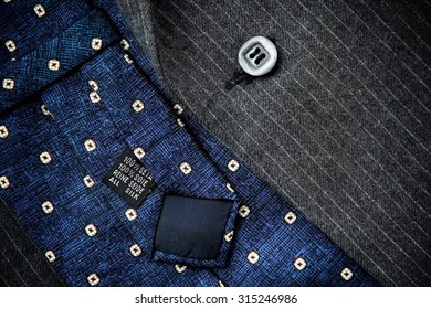 Reverse Of Blue Silk Tie With Men's Black Woolen Suit.