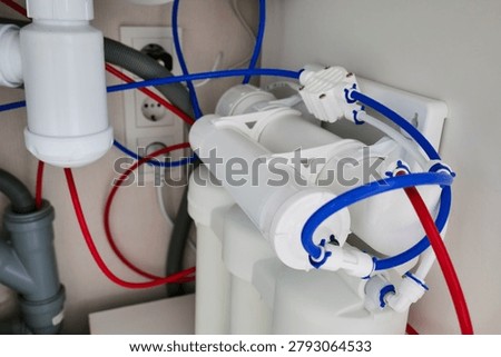 Reverse osmosis water filter system installed under a kitchen sink for household water purification and clean drinking water